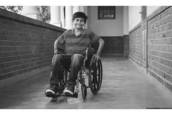 Child in wheelchair in a hallway