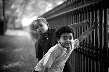 Brothers Playing On a Fence