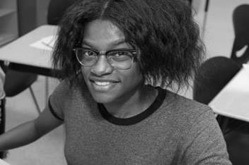 Teen girl and boy working at a computer