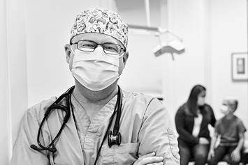Dr. Mike, Urgent Care Physician, Standing in Hallway