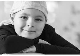 Young smiling cancer patient wearing head wrap 