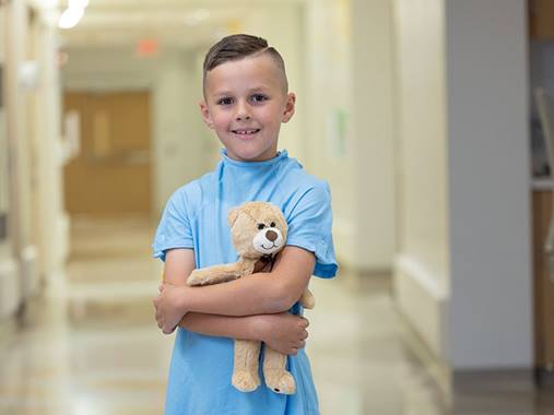 Nationwide Children's Hospital Holiday Campaign Image of Kai Holding a Teddy Bear