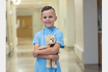 Nationwide Children's Hospital Holiday Campaign Image of Kai Holding a Teddy Bear
