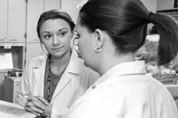 Two female residents discussing a case