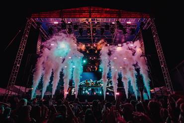 DJ on stage with a big crowd